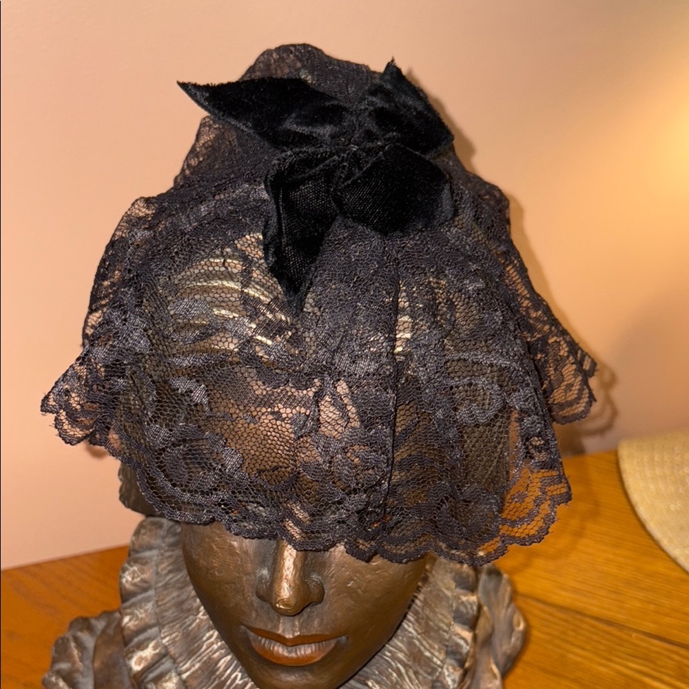 Black Lace Hat with Intricate Patterns and Bow